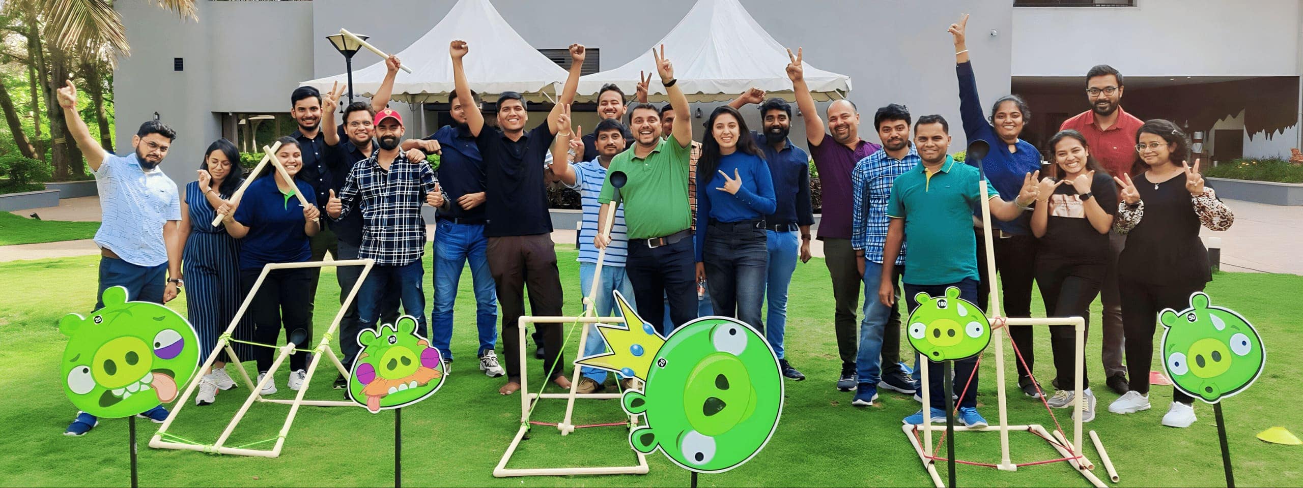 A large group mid-activity, arms raised together in a high-energy moment